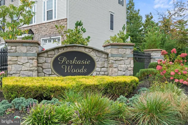 a sign that is sitting in front of flowers