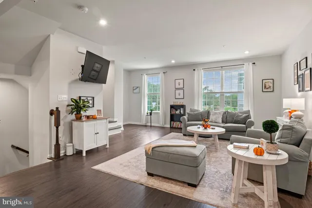 a living room with fireplace furniture and a large window