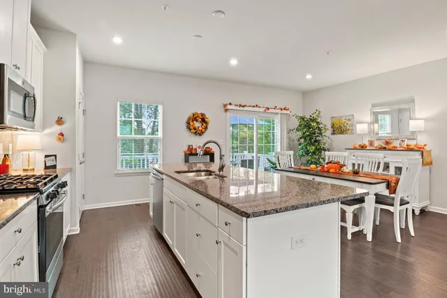 a kitchen with stainless steel appliances granite countertop a stove and a sink