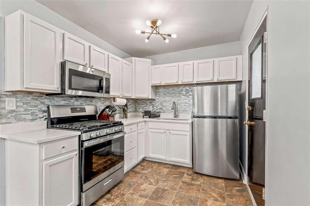 1780 John Calvin Avenue, Unit R College Park, GA 30337 - Photo 5 of 12 a kitchen with a stove a refrigerator and a sink