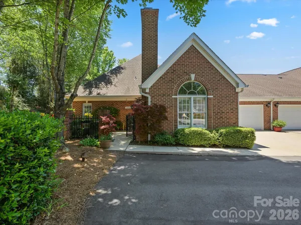 a front view of a house with a yard and a garage