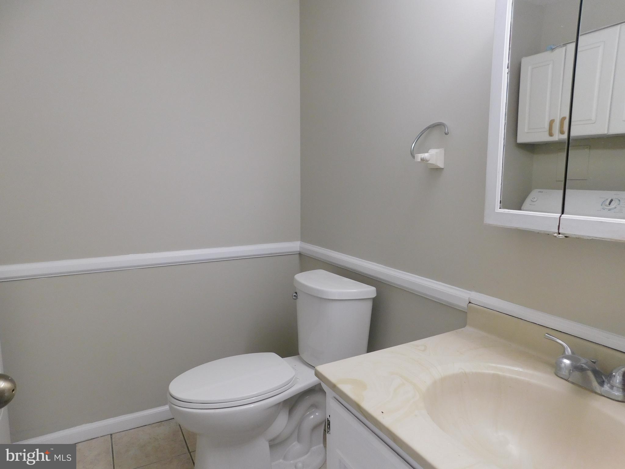 221 East Fairfax Street Berryville, VA 22611 - Photo 7 of 15 a white toilet sitting next to a bathroom sink