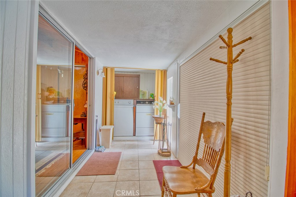 1513 Twin Lakes Road Wrightwood, CA 92397 - Photo 31 of 60 a view of a hallway with furniture and front door