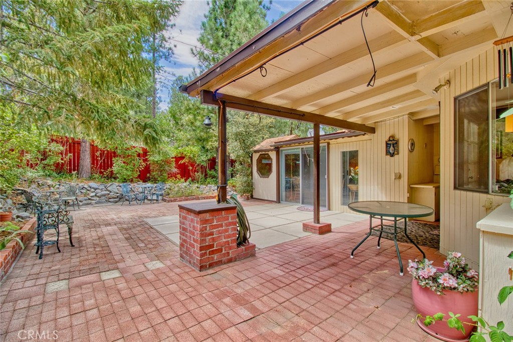 1513 Twin Lakes Road Wrightwood, CA 92397 - Photo 47 of 60 a view of a patio with table and chairs potted plants