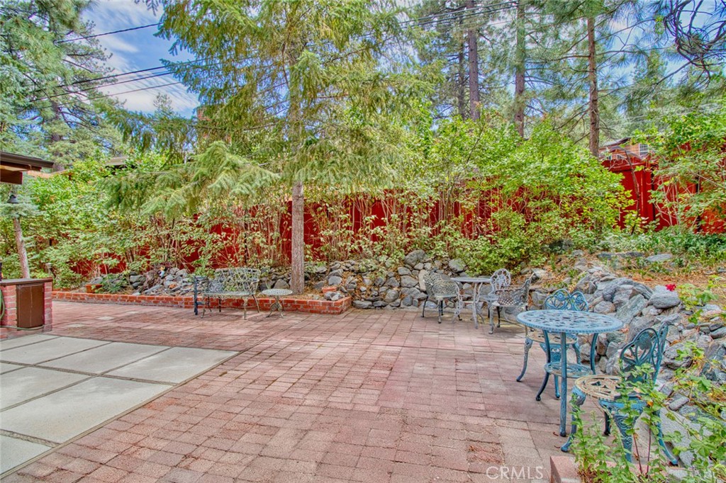 1513 Twin Lakes Road Wrightwood, CA 92397 - Photo 49 of 60 a backyard of a house with lots of green space and fountain