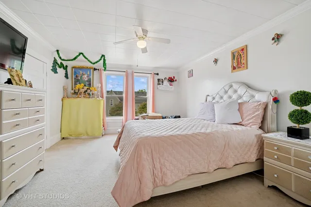 a bedroom with a bed and ceiling fan