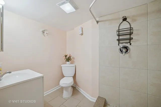 a bathroom with a toilet and a shower