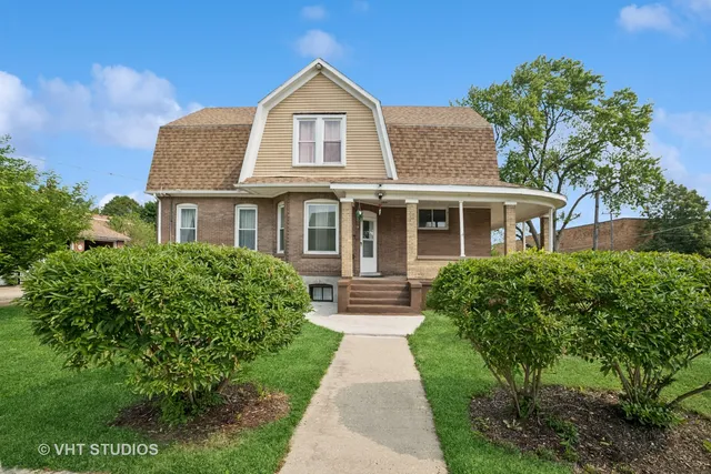 a front view of a house with yard and green space