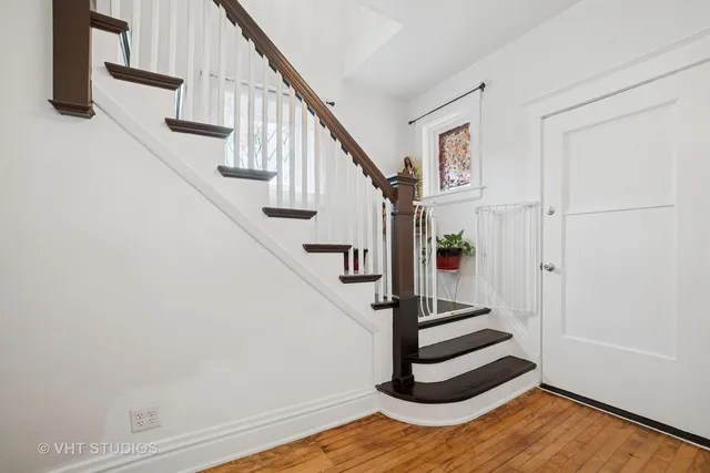 a view of entryway and hall with wooden floor