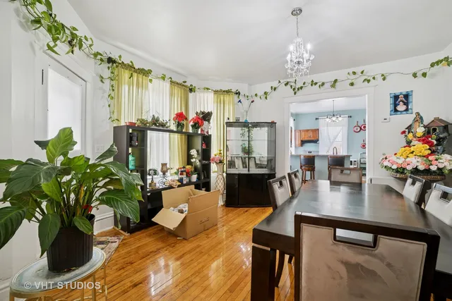 a view of a dining room with furniture and a chandelier