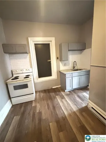 a view of kitchen with sink oven and cabinets