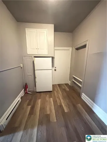 a view of a room with wooden floor