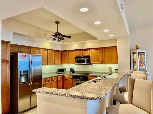 3333 Sunset Key Circle, Unit 303 Punta Gorda, FL 33955 - Photo 13 of 63 a kitchen with stainless steel appliances granite countertop a sink refrigerator and cabinets