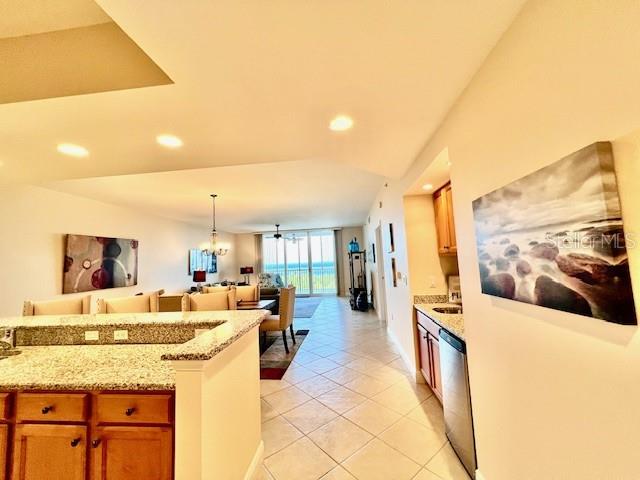 3333 Sunset Key Circle, Unit 303 Punta Gorda, FL 33955 - Photo 21 of 63 a large kitchen with kitchen island a large counter top stainless steel appliances and cabinets