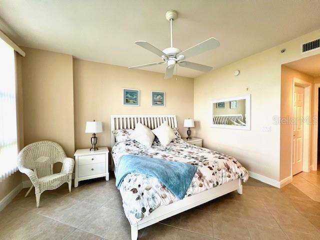 3333 Sunset Key Circle, Unit 303 Punta Gorda, FL 33955 - Photo 26 of 63 a bedroom with a bed and a chandelier