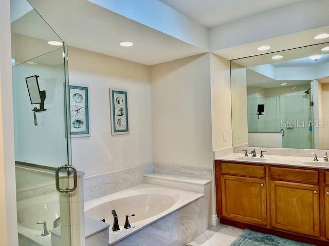 3333 Sunset Key Circle, Unit 303 Punta Gorda, FL 33955 - Photo 27 of 63 a bathroom with a tub sink and mirror