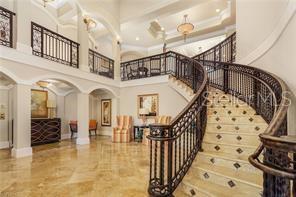 3333 Sunset Key Circle, Unit 303 Punta Gorda, FL 33955 - Photo 34 of 63 a view of staircase with lots of frames on wall and a chandelier