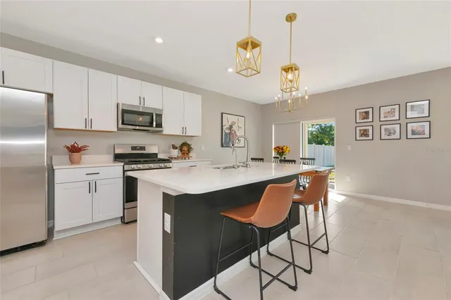 a view of a dining room with furniture and chandelier