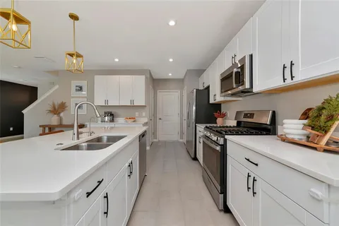 a kitchen with stainless steel appliances granite countertop a stove a microwave and cabinets