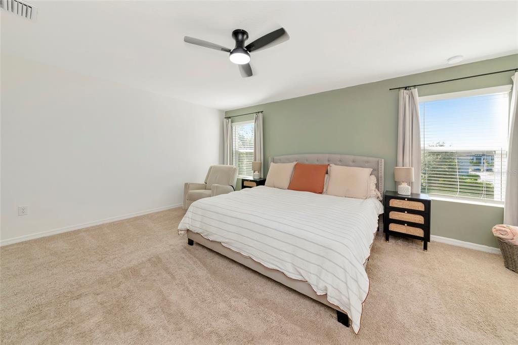 6283 Springmont Loop Palmetto, FL 34221 - Photo 28 of 68 a bedroom with a bed and a chandelier