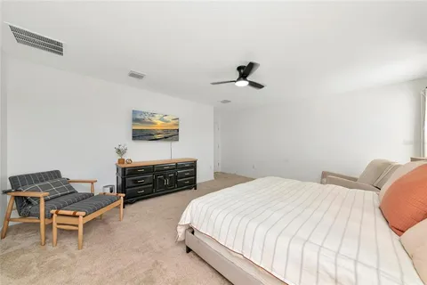 a bedroom with a bed and a large window