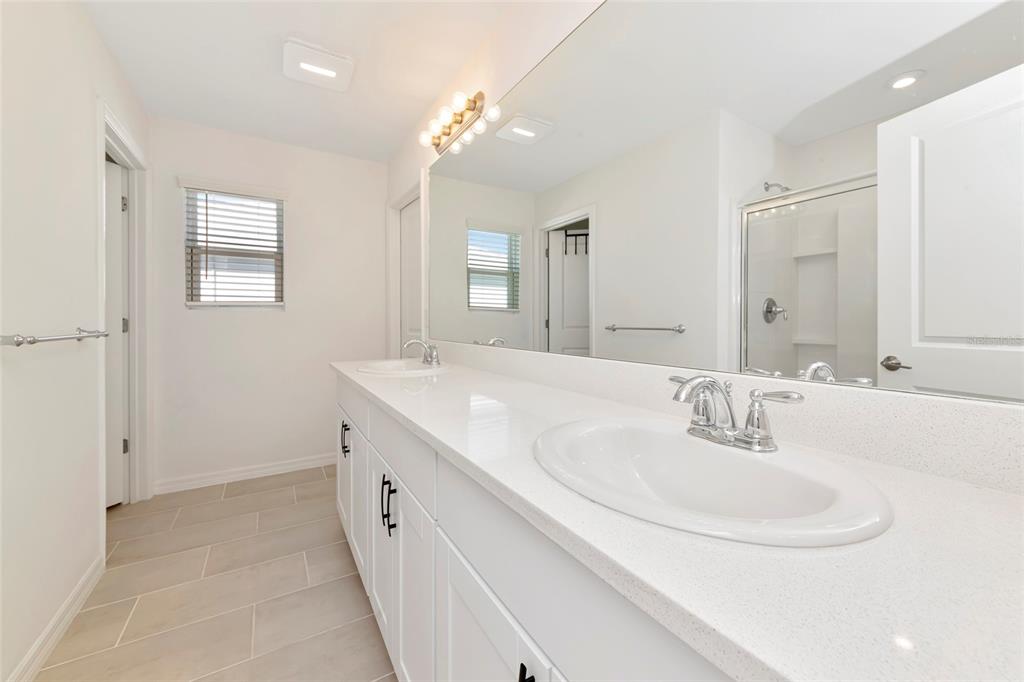 6283 Springmont Loop Palmetto, FL 34221 - Photo 31 of 68 a bathroom with a double vanity sink and a mirror