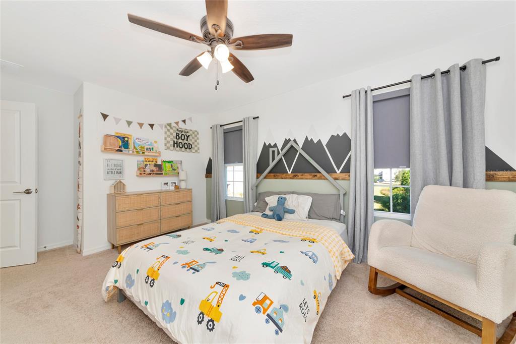 6283 Springmont Loop Palmetto, FL 34221 - Photo 35 of 68 a bedroom with a bed couch and a window