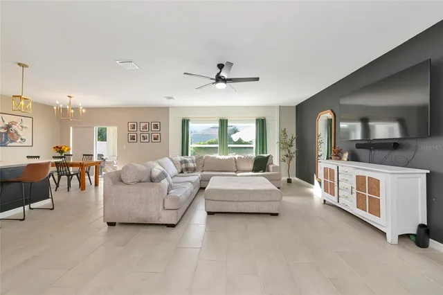 a kitchen with kitchen island granite countertop a sink cabinets stainless steel appliances and a window