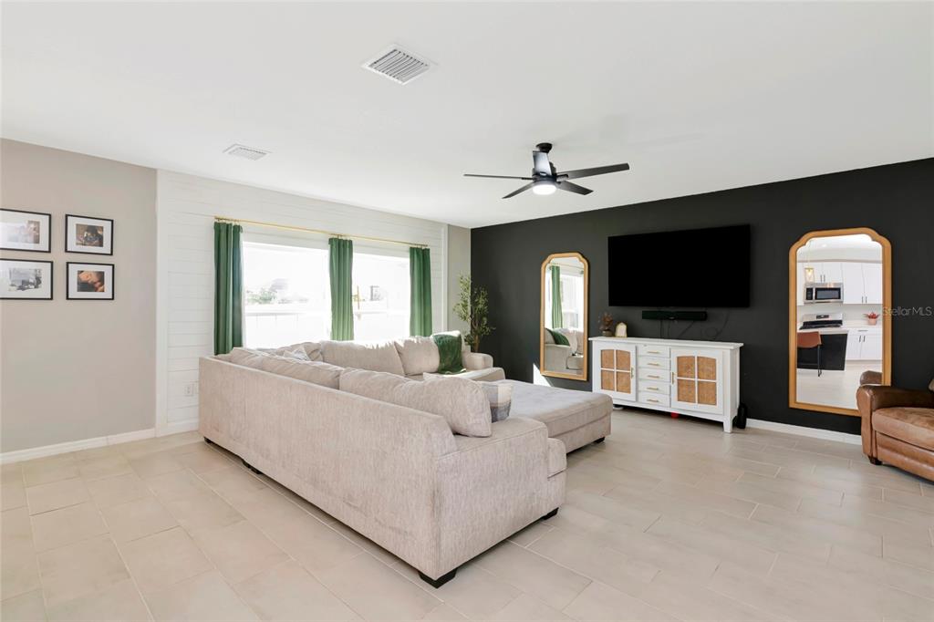 6283 Springmont Loop Palmetto, FL 34221 - Photo 10 of 68 a living room with furniture and a flat screen tv
