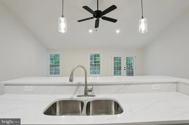 a kitchen with a sink and chandelier