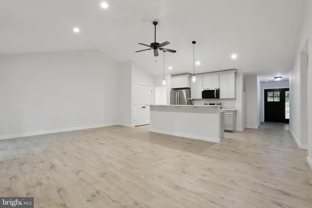 a view of a kitchen with a sink and a refrigerator