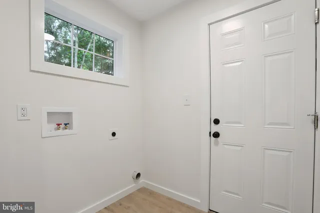 a view of swimming pool with a large trees and wooden fence