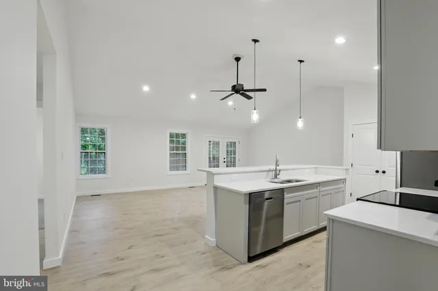 a kitchen with a sink stove and cabinets