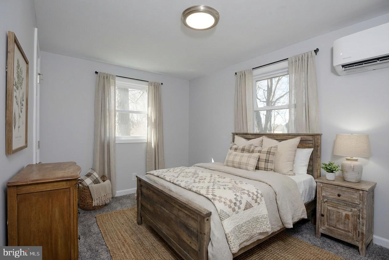 6374 Rock Hall Road Rock Hall, MD 21661 - Photo 12 of 34 a bedroom with a bed and wooden floor