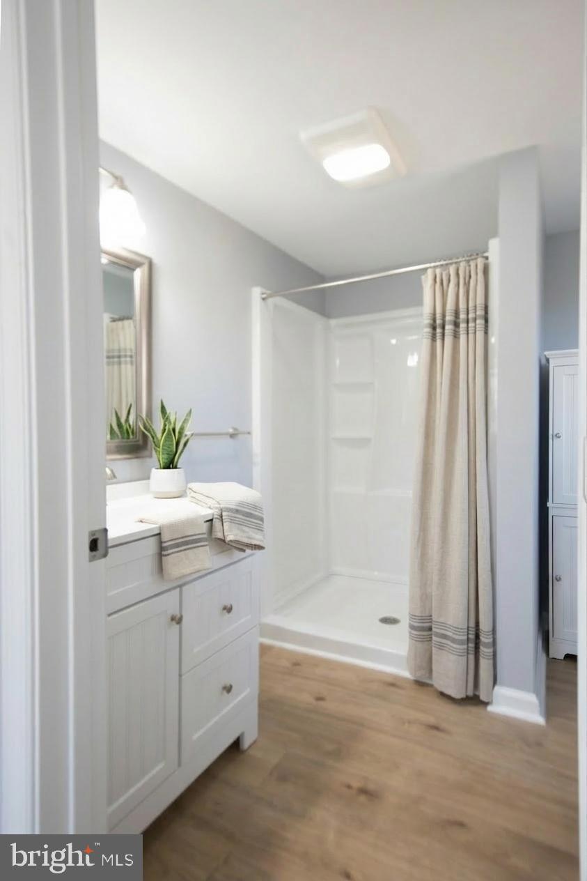 6374 Rock Hall Road Rock Hall, MD 21661 - Photo 2 of 34 a bathroom with a double vanity sink and a mirror