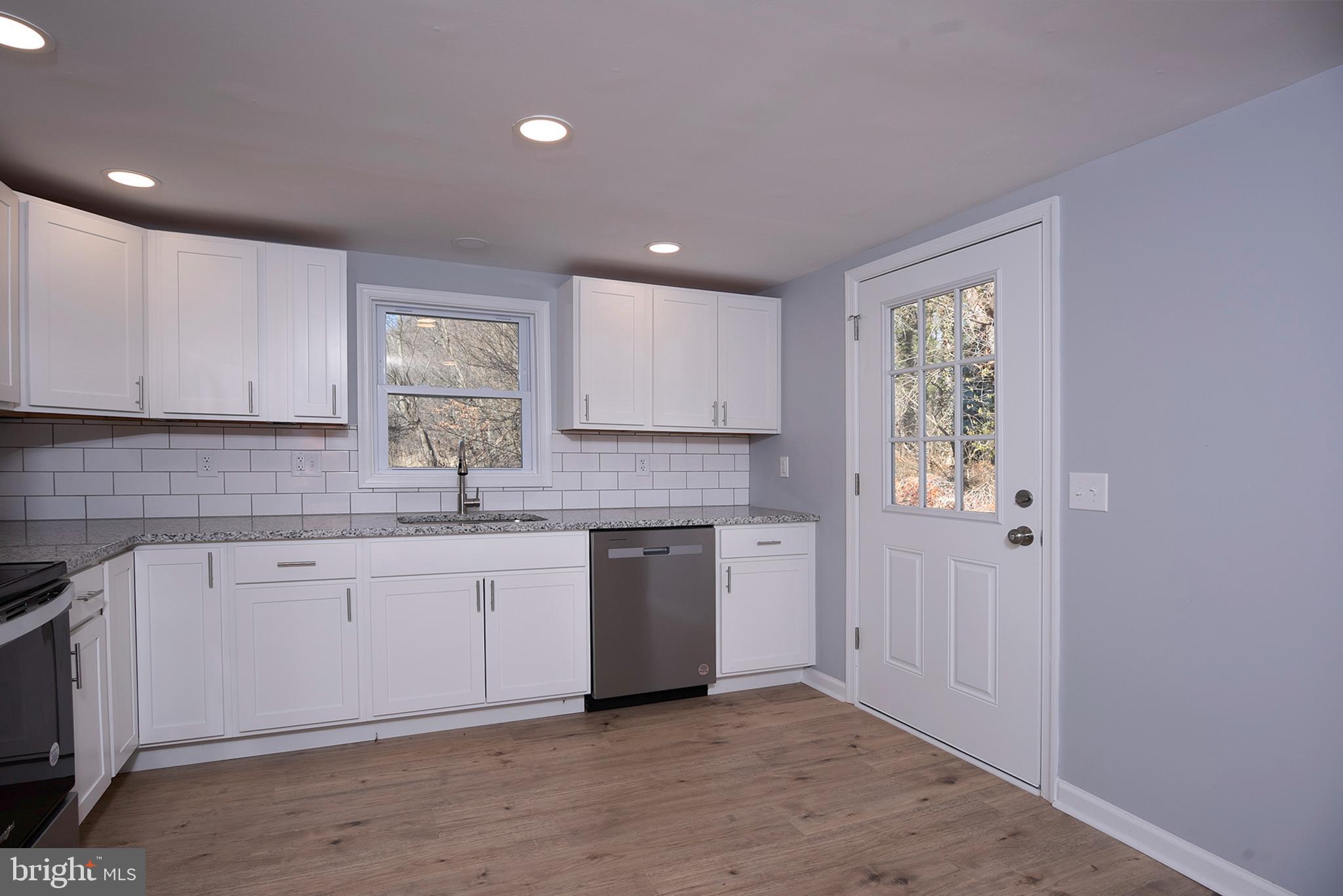 6374 Rock Hall Road Rock Hall, MD 21661 - Photo 8 of 34 a kitchen with a sink window and cabinets