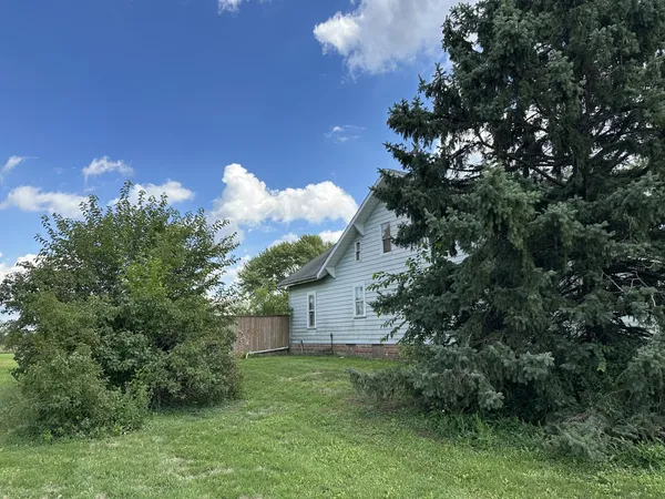 a view of a house with a backyard and a garden