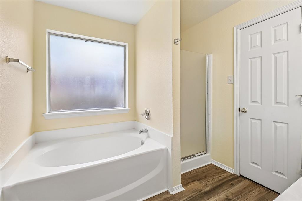 5609 Saddleback Road Arlington, TX 76017 - Photo 17 of 23 a white bath tub sitting next to a window