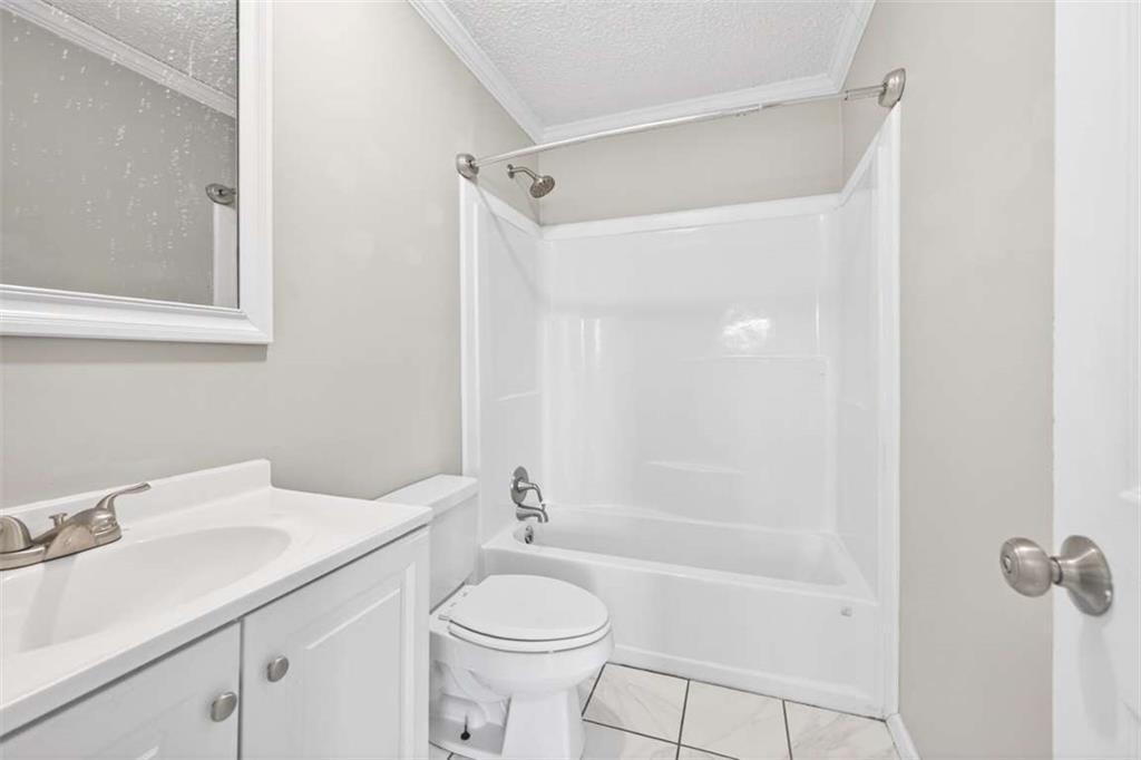3696 Crabapple Hollow Road Nicholson, GA 30565 - Photo 22 of 38 a bathroom with a sink a toilet and shower