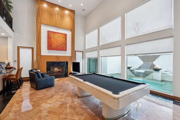 a living room with a fireplace furniture and a large window
