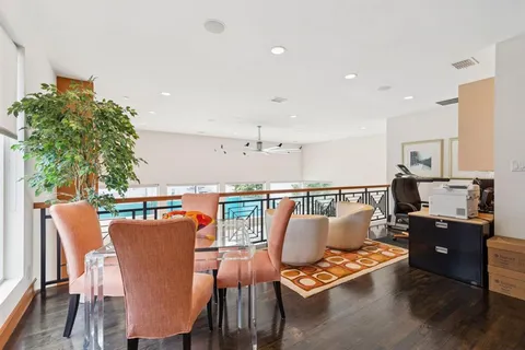 a dining room with furniture window and wooden floor
