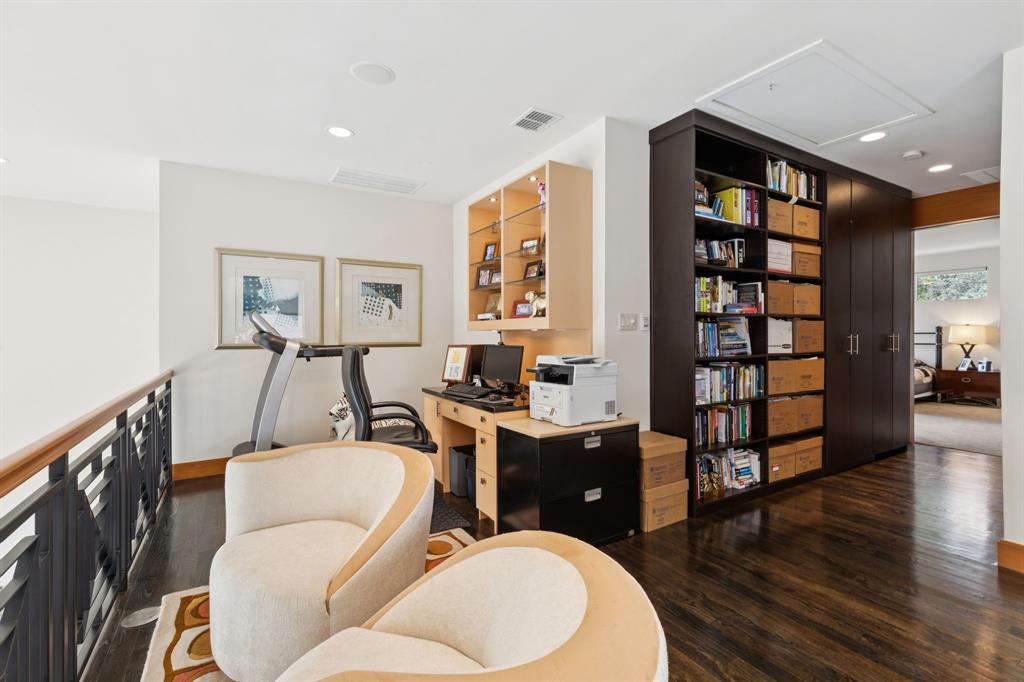 5730 West Amherst Avenue Dallas, TX 75209 - Photo 23 of 40 a living room with furniture a rug and a bookshelf
