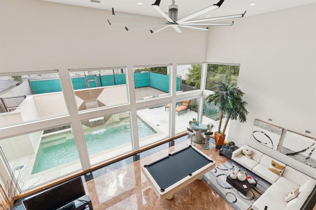 5730 West Amherst Avenue Dallas, TX 75209 - Photo 23 of 40 a living room with a bed furniture and a large window