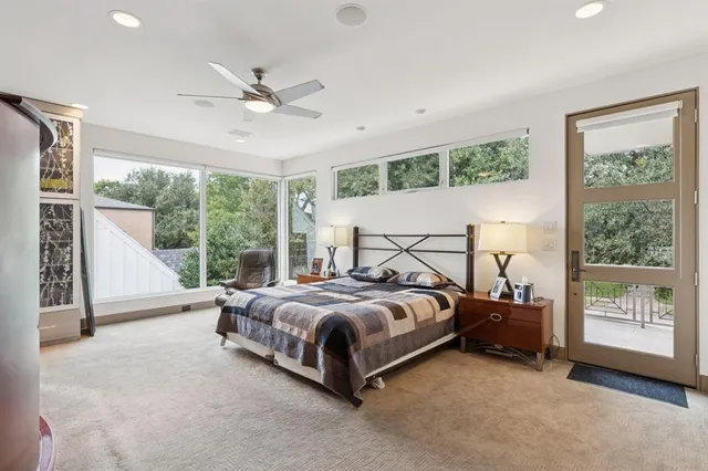 a bedroom with a bed a couch and a window