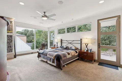 a bedroom with a bed a couch and a window