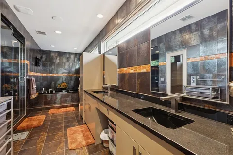 a bathroom with a glass shower door
