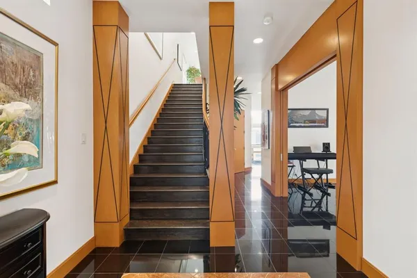 a view of entryway and hall with wooden floor