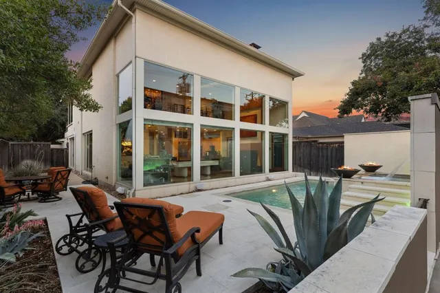 a view of a patio with table and chairs and potted plants with wooden fence