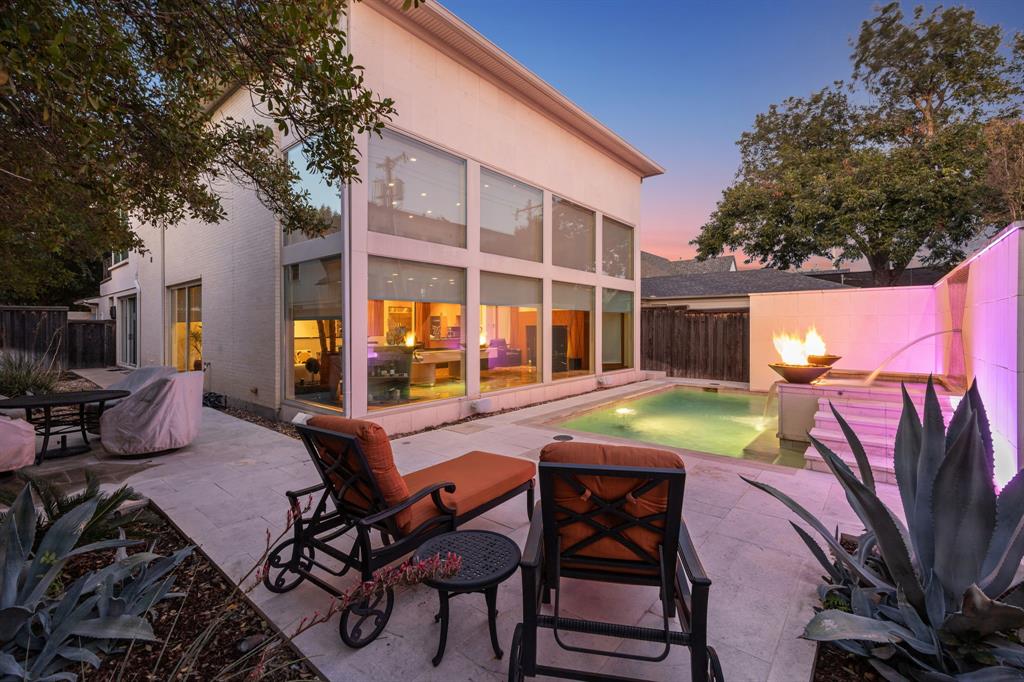 5730 West Amherst Avenue Dallas, TX 75209 - Photo 38 of 40 a view of a patio with table and chairs and potted plants with wooden fence