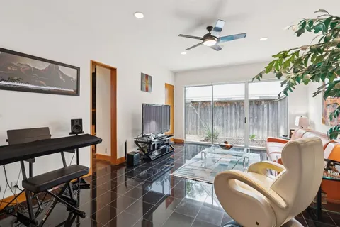 a work room with furniture and a large window